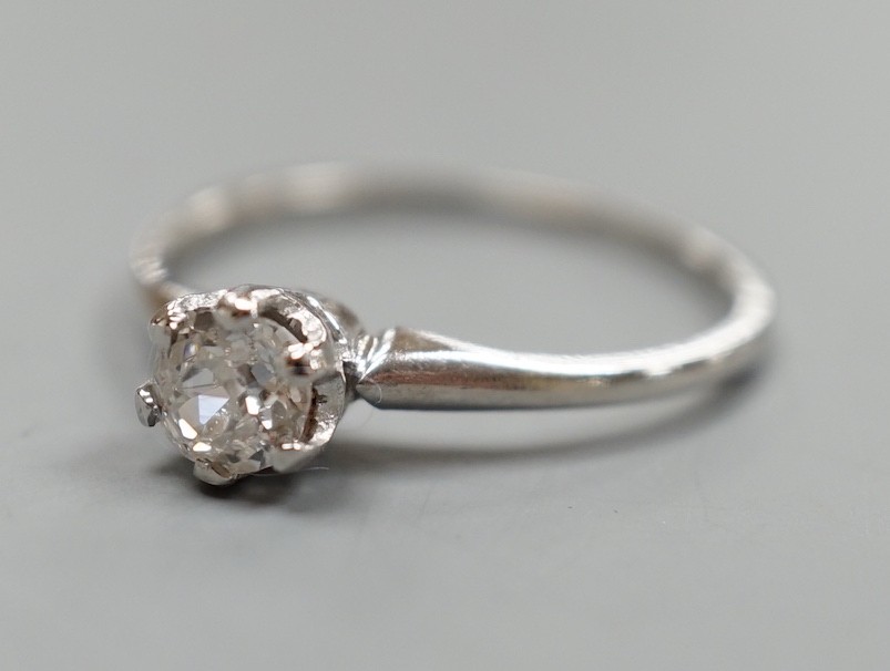 A white metal (stamped plat) and solitaire diamond ring, size O, gross weight 2.3 grams.